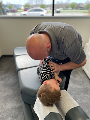 Chiropractor Grand Rapids MI Joseph House Adjusting Boy