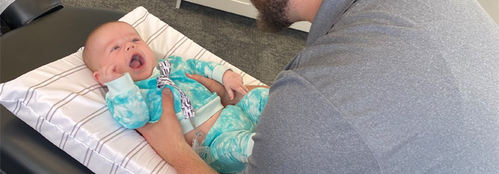 Chiropractor Grand Rapids MI Joseph House Adjusting Infant