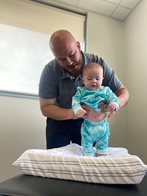 Chiropractor Grand Rapids MI Joseph House Holding Infant