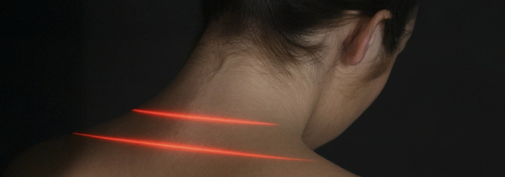 A person with red lasers on their neck.